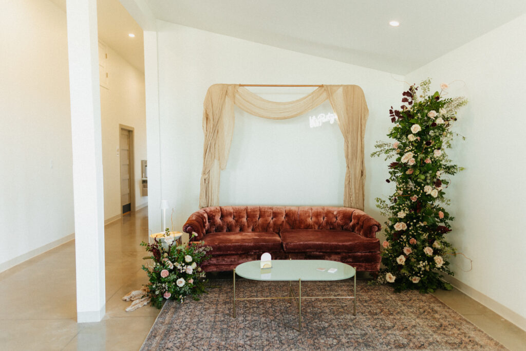 couch and fresh floral setup inside ahahah wedding venue