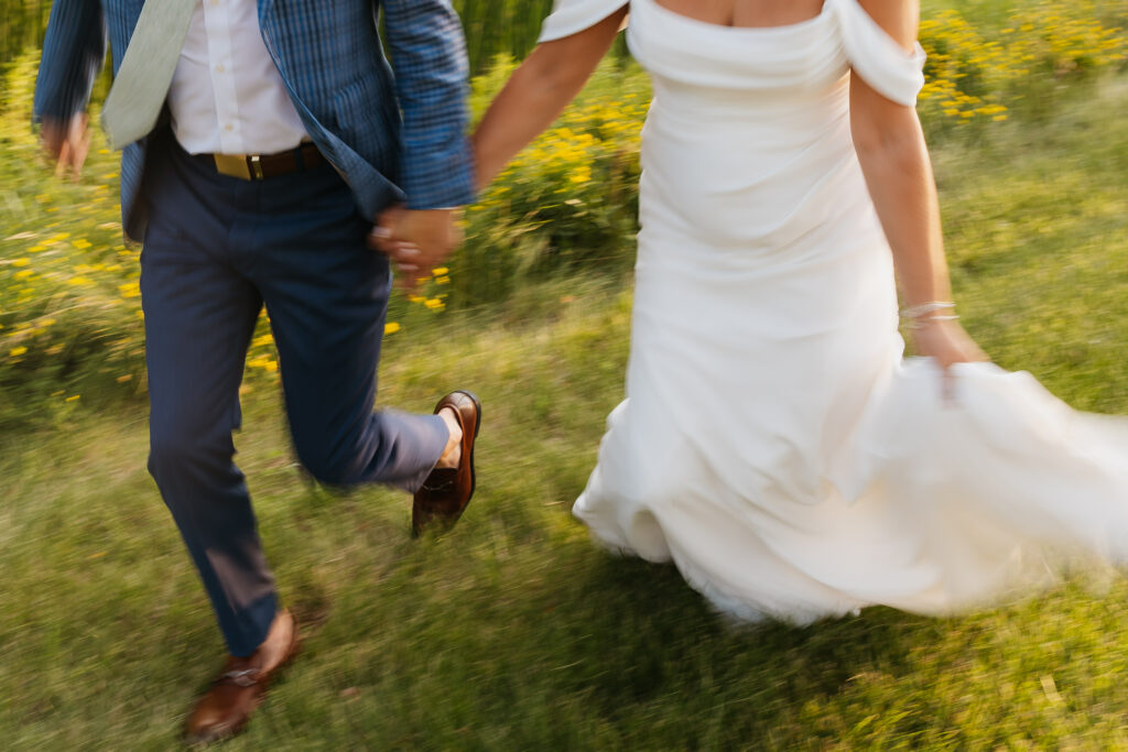 bride and groom running at sunset at Hilton garden inn cedar falls